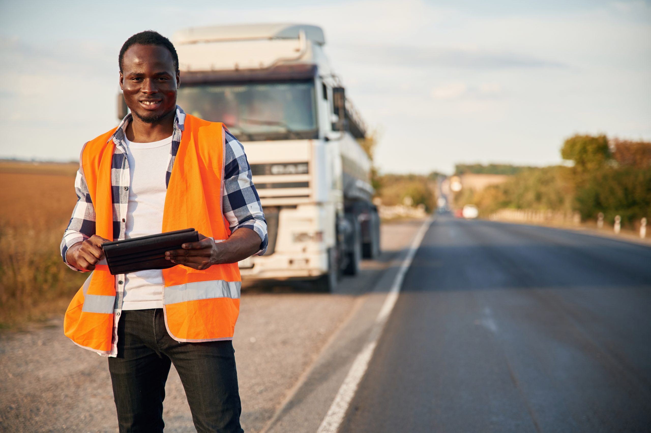 truck-is-behind-black-man-is-standing-on-the-road-2023-11-29-02-06-25-utc-scaled
